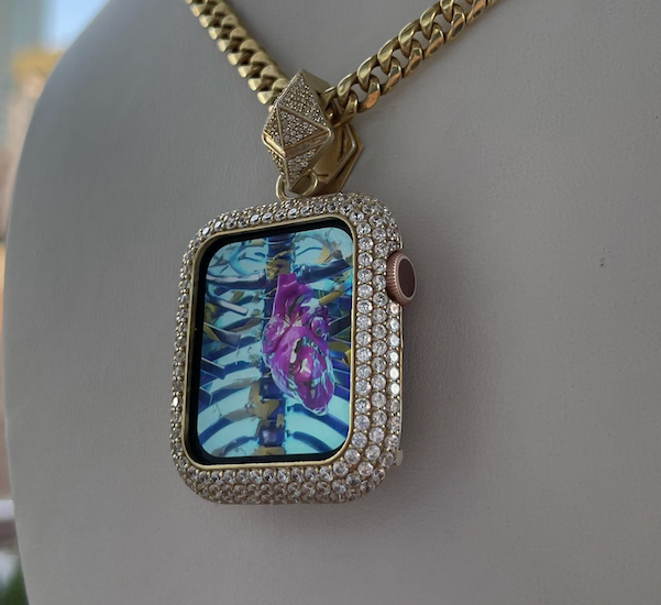 diamond studded pendant on gold chain with colorful art display