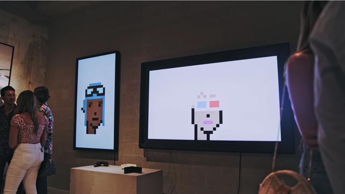 gallery with digital displays featuring cryptopunks